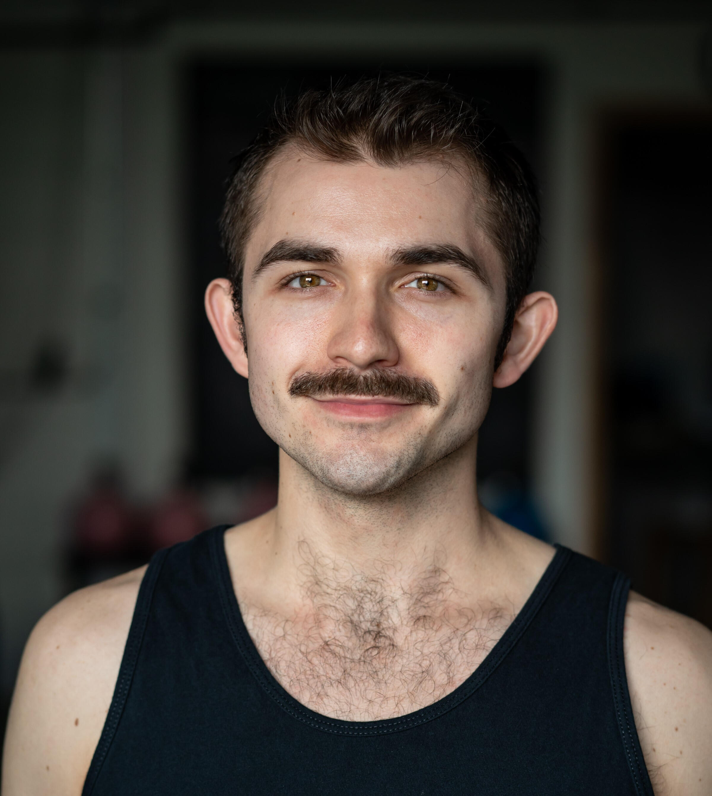 Spencer Schunk man with short brown hair, hazel eyes, and moustache
